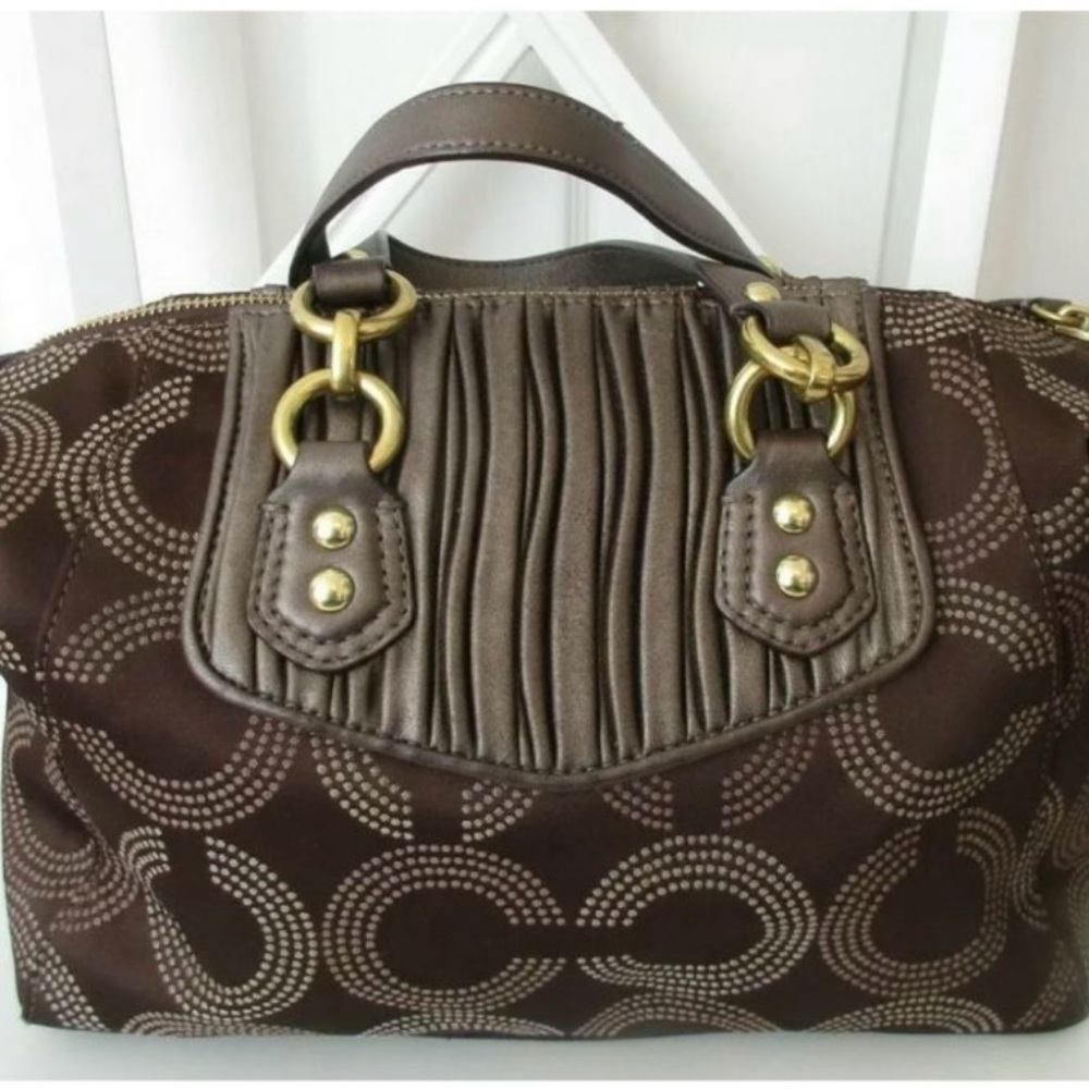 Coach rarely used. Brown with pink lining inside. Good Condition
